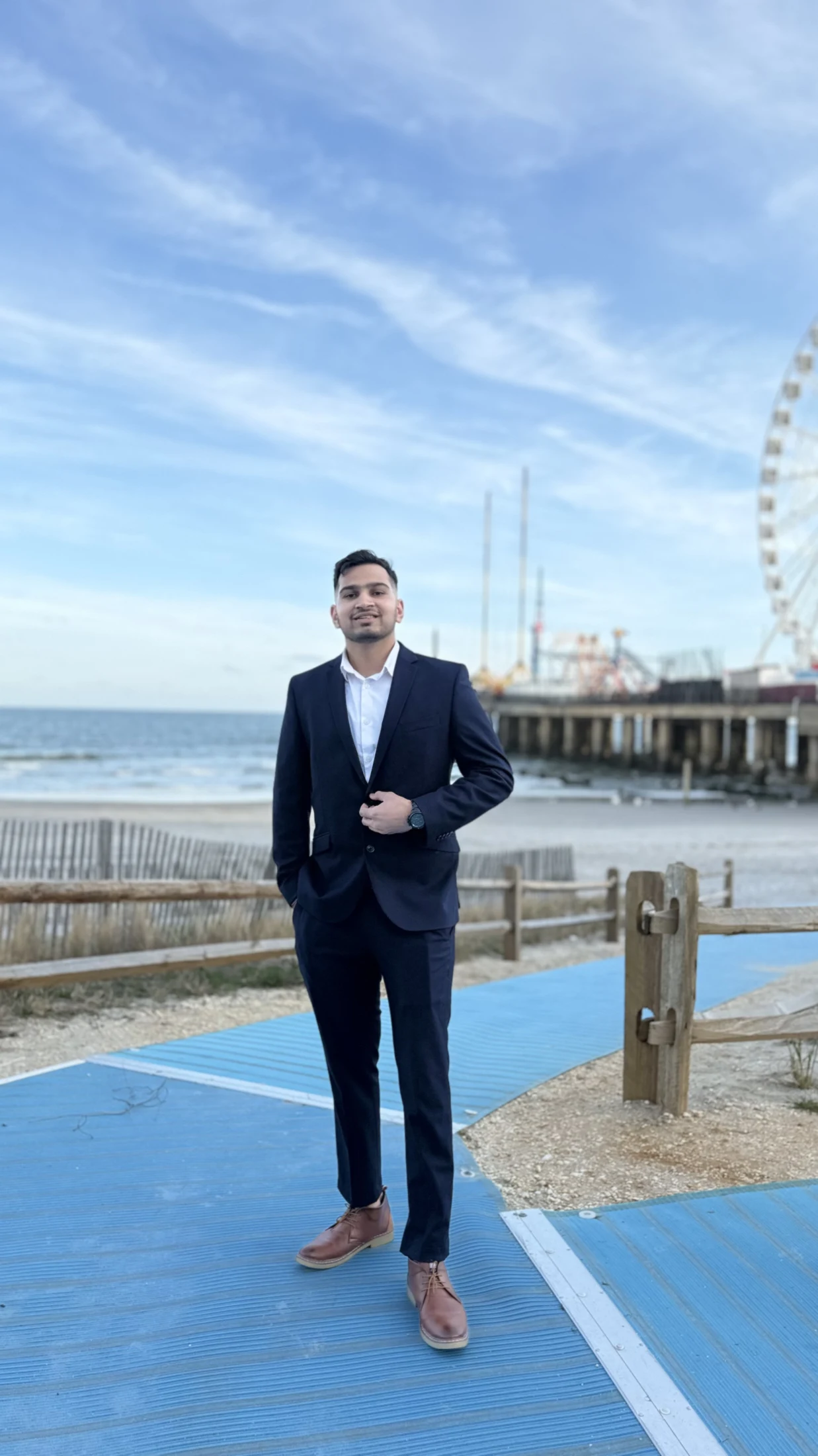Dhyan in a navy suit by the waterfront